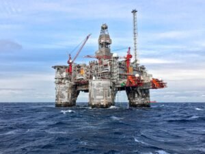 An offshore oil platform in Norway's North Sea under a clear blue sky.